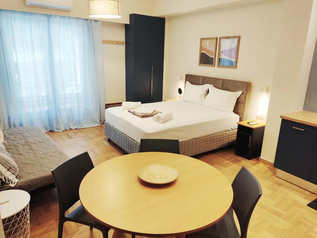 a hotel room with a bed and a table and chairs at Acropolis Oasis by YHA in Athens