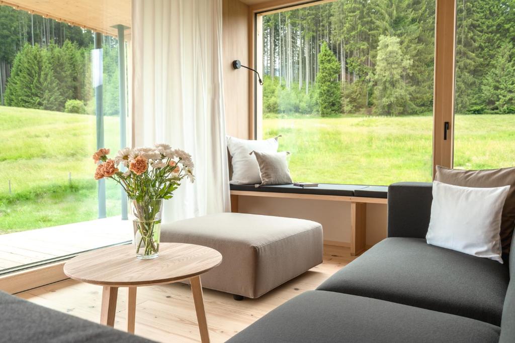 a living room with a vase of flowers on a table at Freiheit in Bolsterlang