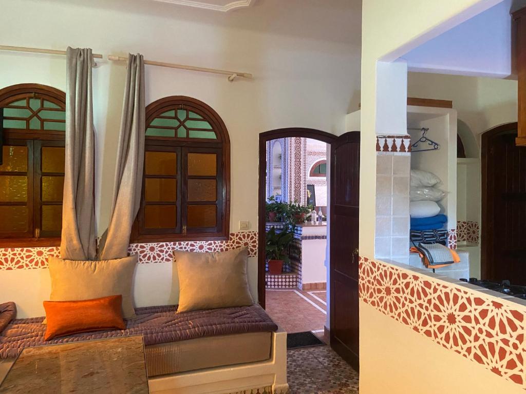 a living room with a couch and a window at Riad Salt River in Martil