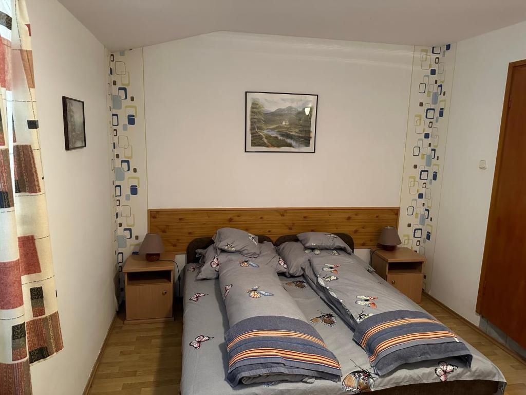 a large bed in a room with two tables at Park Hédervár in Hédervár