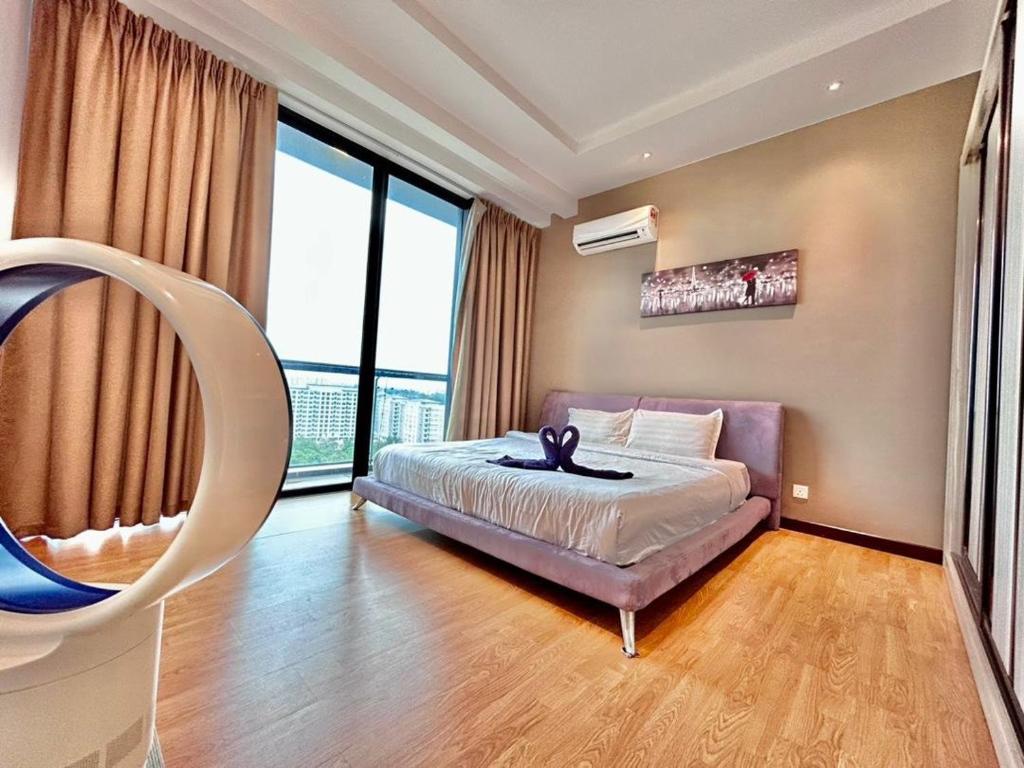 a bedroom with a bed and a large window at Jeff and Ricky Homestay 8 Boulevard Imperial Suites in Kuching