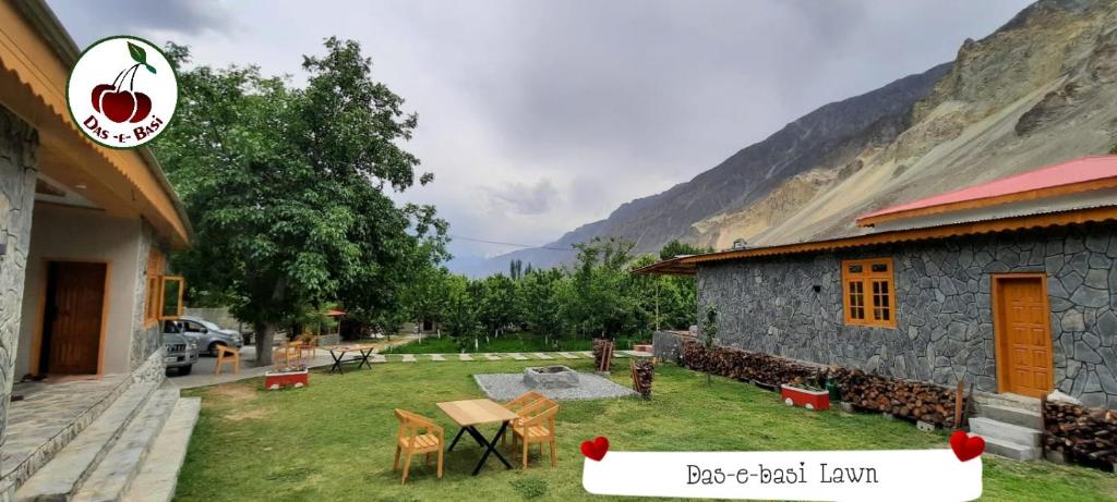 a house with a yard next to a mountain at Das-e-Basi in Gilgit