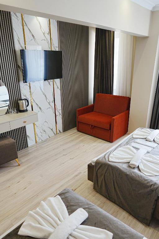 A bed or beds in a room at Reyyan Hotel
