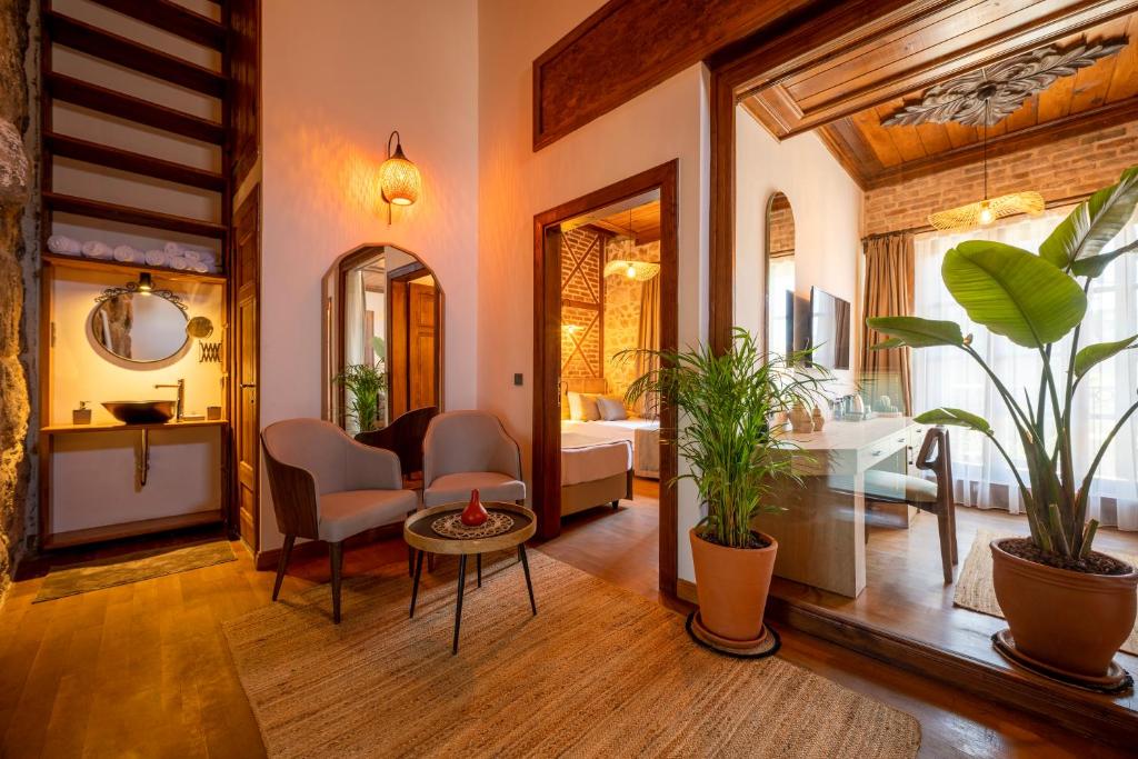 a living room with a bed and a table with plants at Route Hotel Kaleici - Adult Only (12+) in Antalya