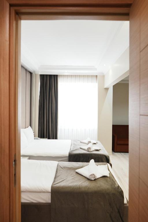 A bed or beds in a room at Reyyan Hotel