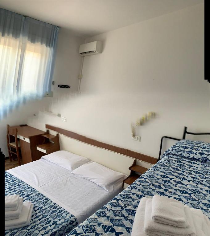 Postel nebo postele na pokoji v ubytování Hotel Estense