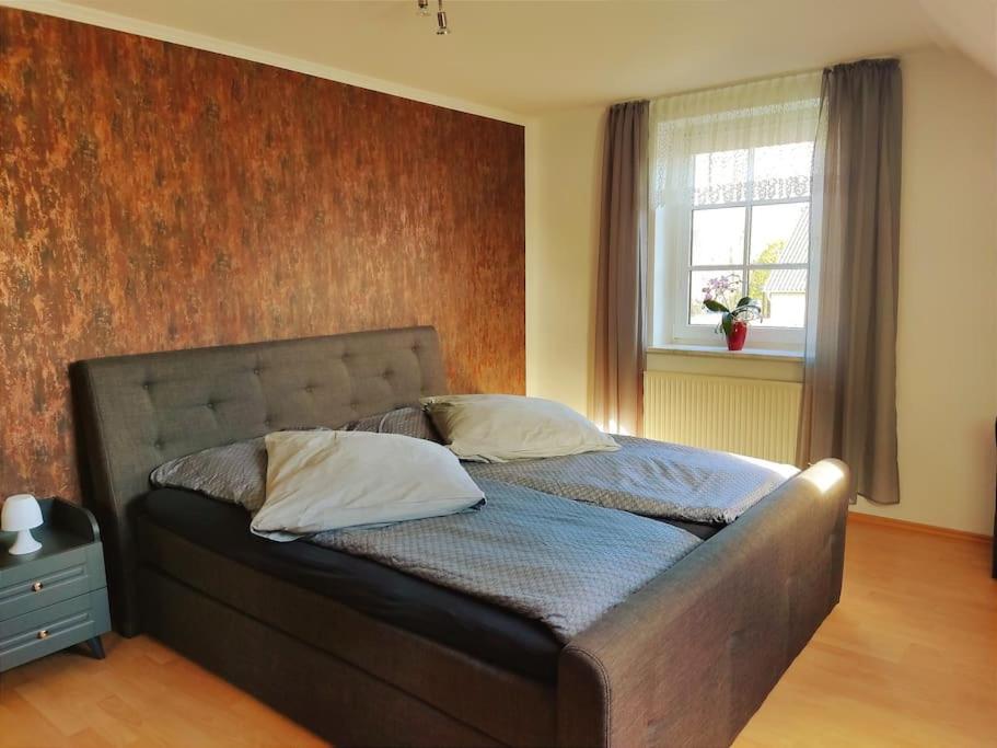a bed with two pillows on it in a bedroom at Ferienwohnung nahe der Ostsee in Steinhagen