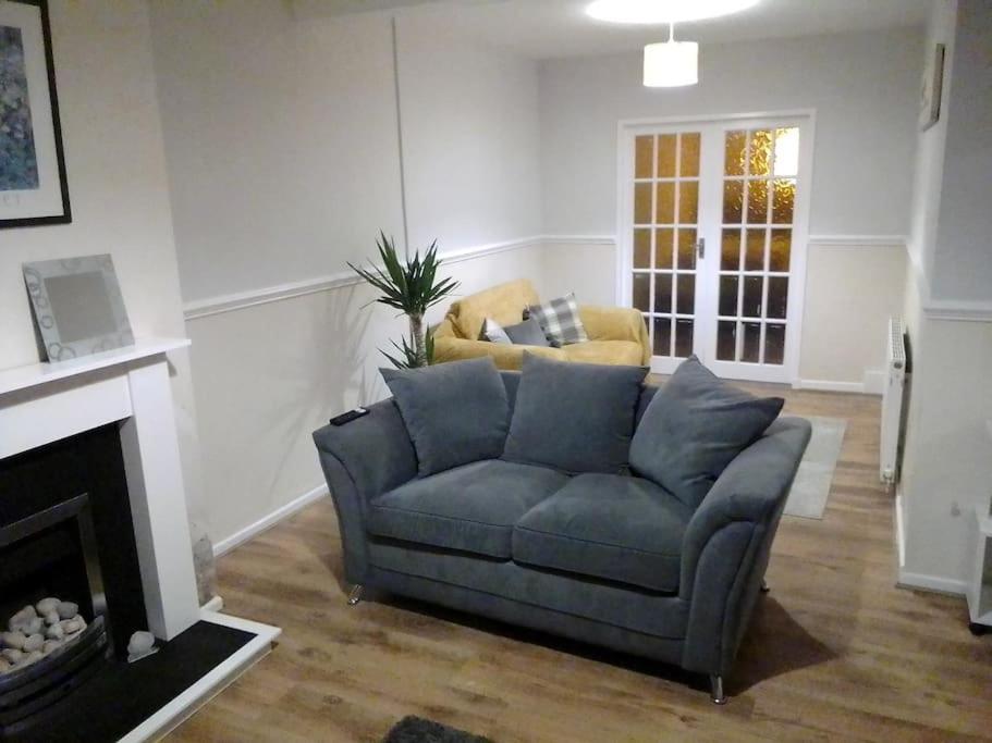 a living room with a couch and a fireplace at Blackpool Holiday Home - Forshaw House in Blackpool