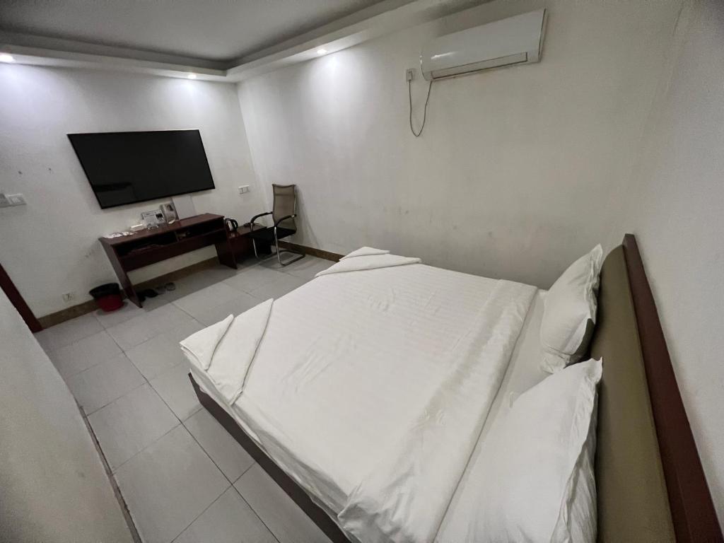 Postel nebo postele na pokoji v ubytování Yaou Hotel