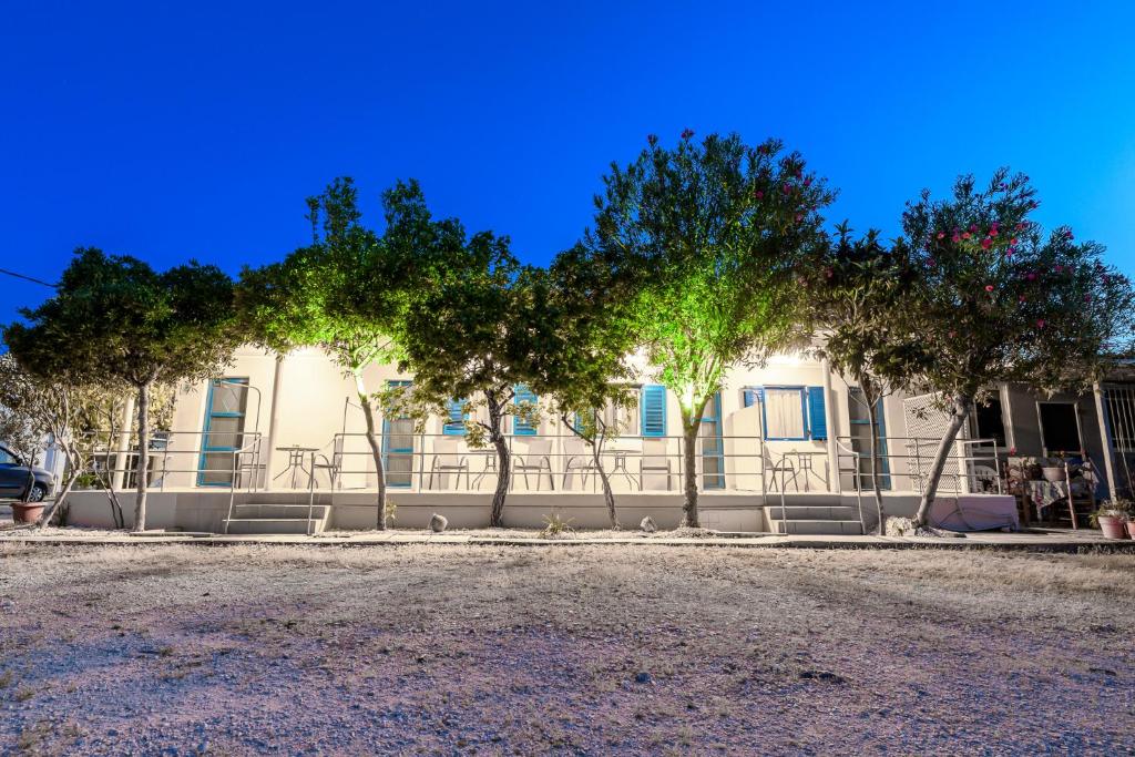 a white building with trees in front of it at Zante Riva Studios in Lithakia