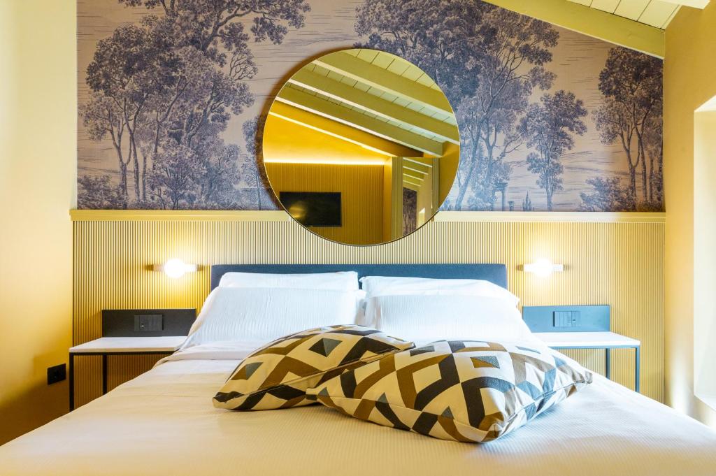 a bedroom with a bed with a mirror on the wall at Albergo La Braseria in Osio Sotto