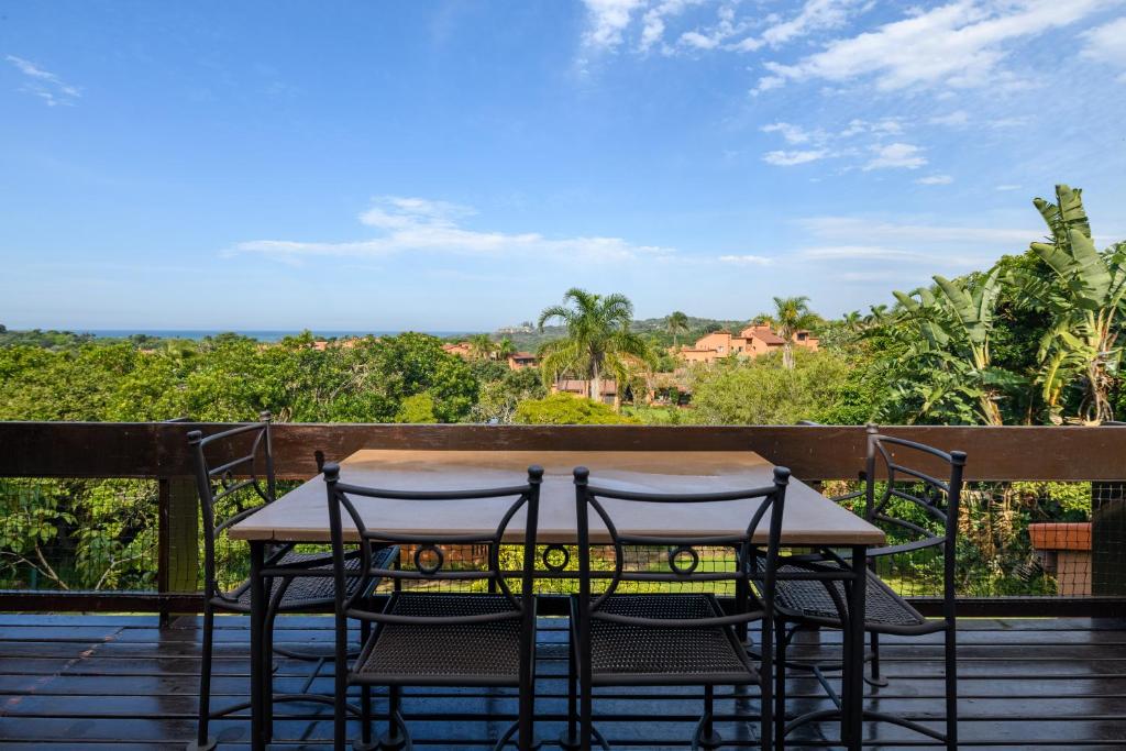 a table and chairs on a deck with a view at San Lameer Villa 2409 - 3 Bedroom Standard - 6 pax - San Lameer Rental Agency in Southbroom