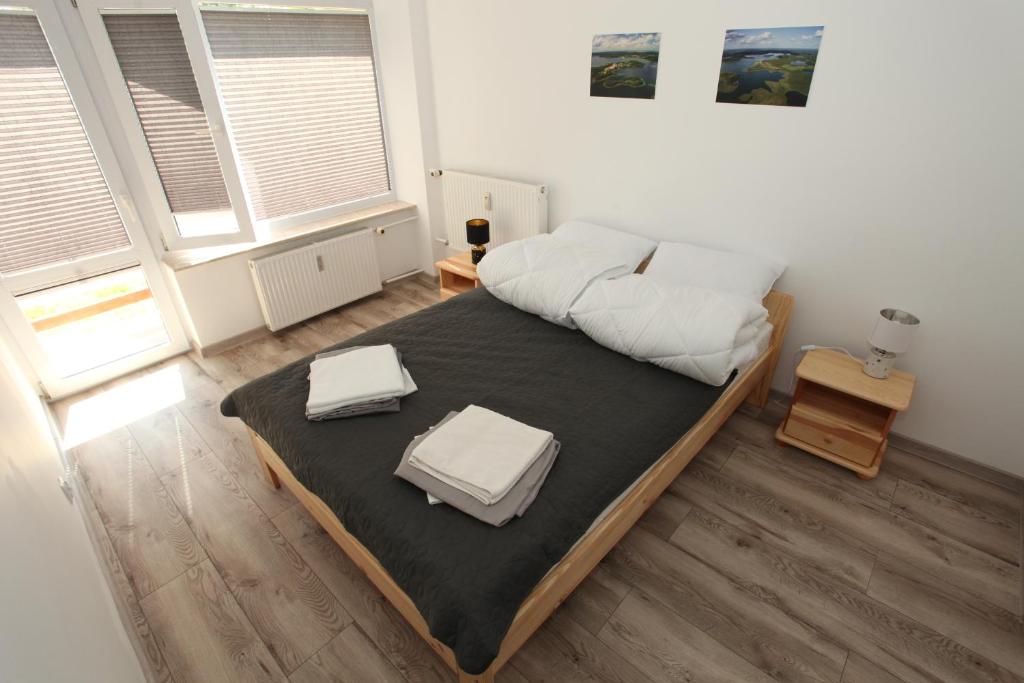 a bedroom with a large bed with white pillows on it at Wigierski Park Narodowy in Suwałki