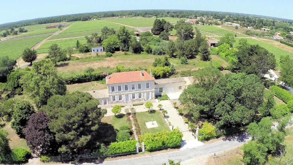 an aerial view of a large house in a field at Le Manoir Lacustre in Queyrac