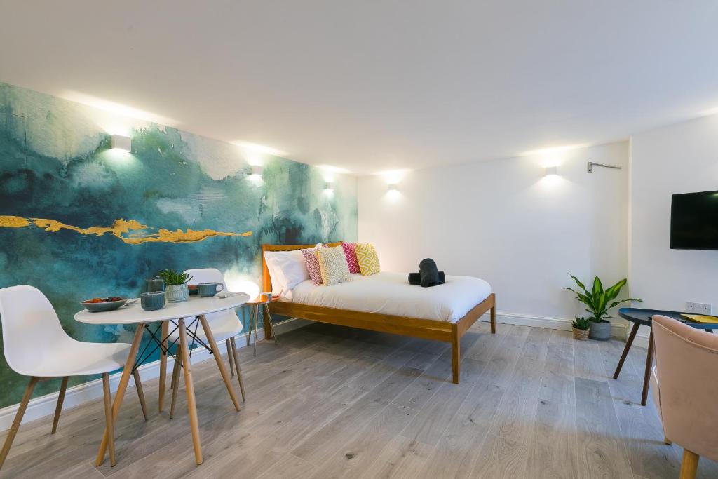 a bedroom with a bed and a table and chairs at Island Studio with on-site parking in St Ives