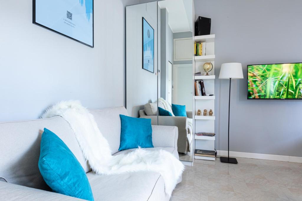 a living room with a white couch and blue pillows at Collection CityLife Suites with Terrace - Top Collection in Milan