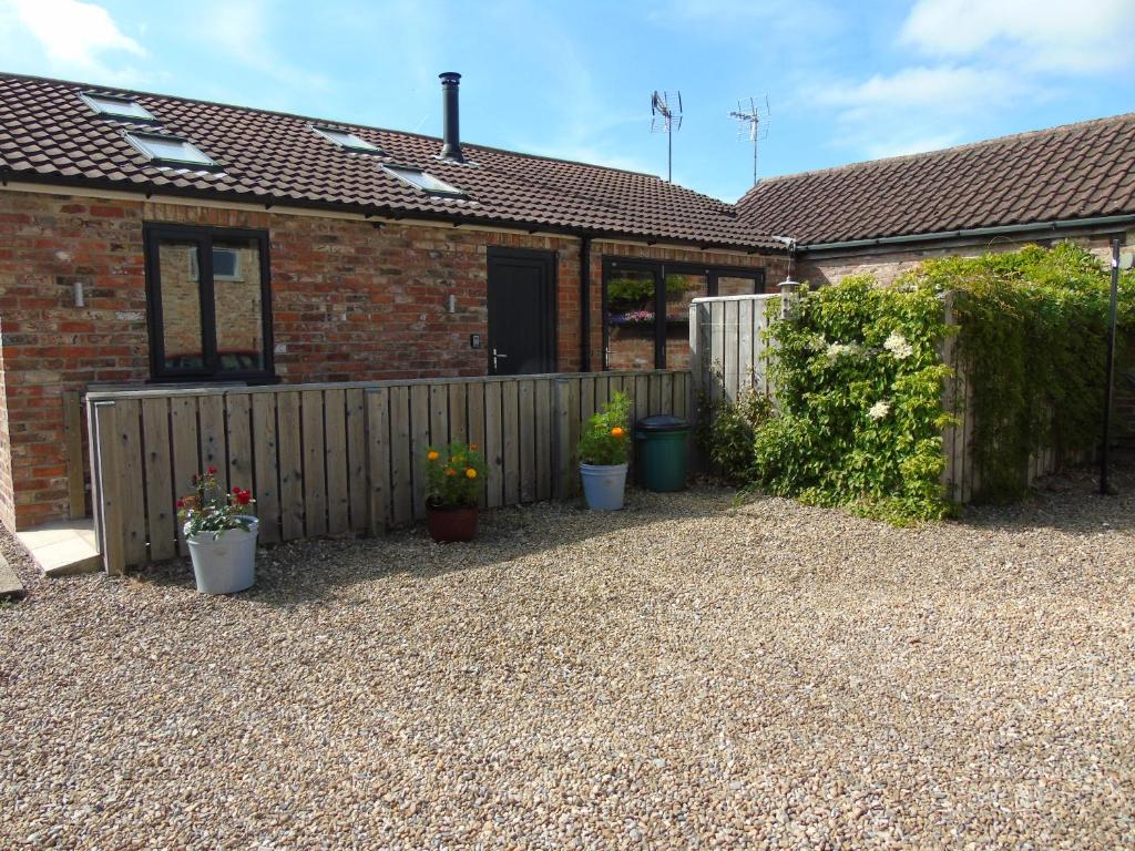 a house with a fence and some potted plants at The Retreat in York