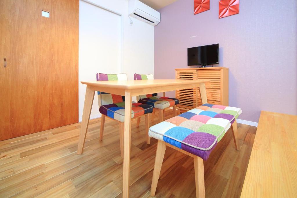a room with a table and chairs and a tv at 柏・二条1（Haku Nijo1） in Kyoto
