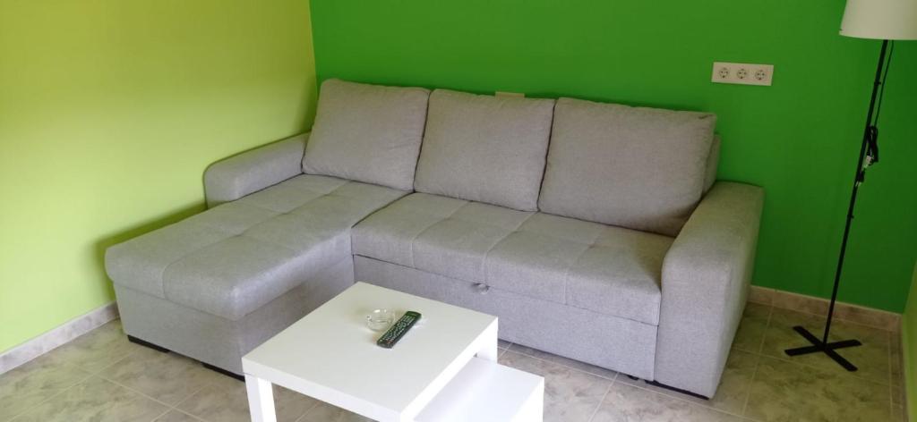 a living room with a couch and a table at Apartamentos M° Esther in A Lanzada