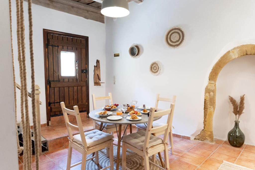 a dining room with a table and chairs at Tethys 3 by Cretan Pnoe Adults Only in Kolymvari