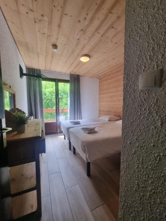 Postel nebo postele na pokoji v ubytování Hotel Le Cairn