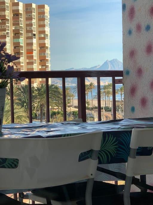 a balcony with a table and two chairs on a balcony at Apartamento Alicante San Juan playa 1ª línea in Benimagrell