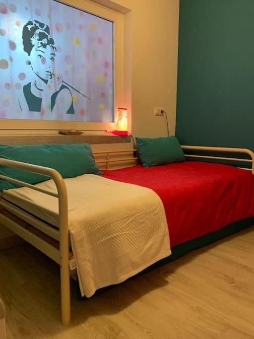 a bedroom with a bed with a red blanket at Apartamento Alicante San Juan playa 1ª línea in Benimagrell