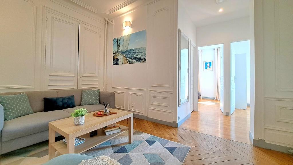 un salon avec un canapé et une table dans l'établissement Les Matelots Rouen Centre by MyFrenchPAT, à Rouen