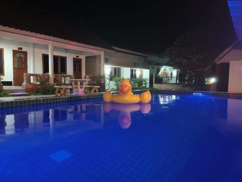 a large rubber duck in a swimming pool at night at Pai Family Resort in Pai
