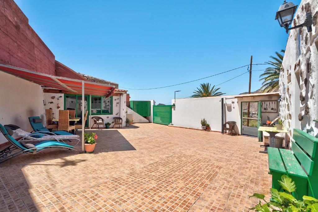 a patio of a house with a building at Rosa del Negro in Alojera