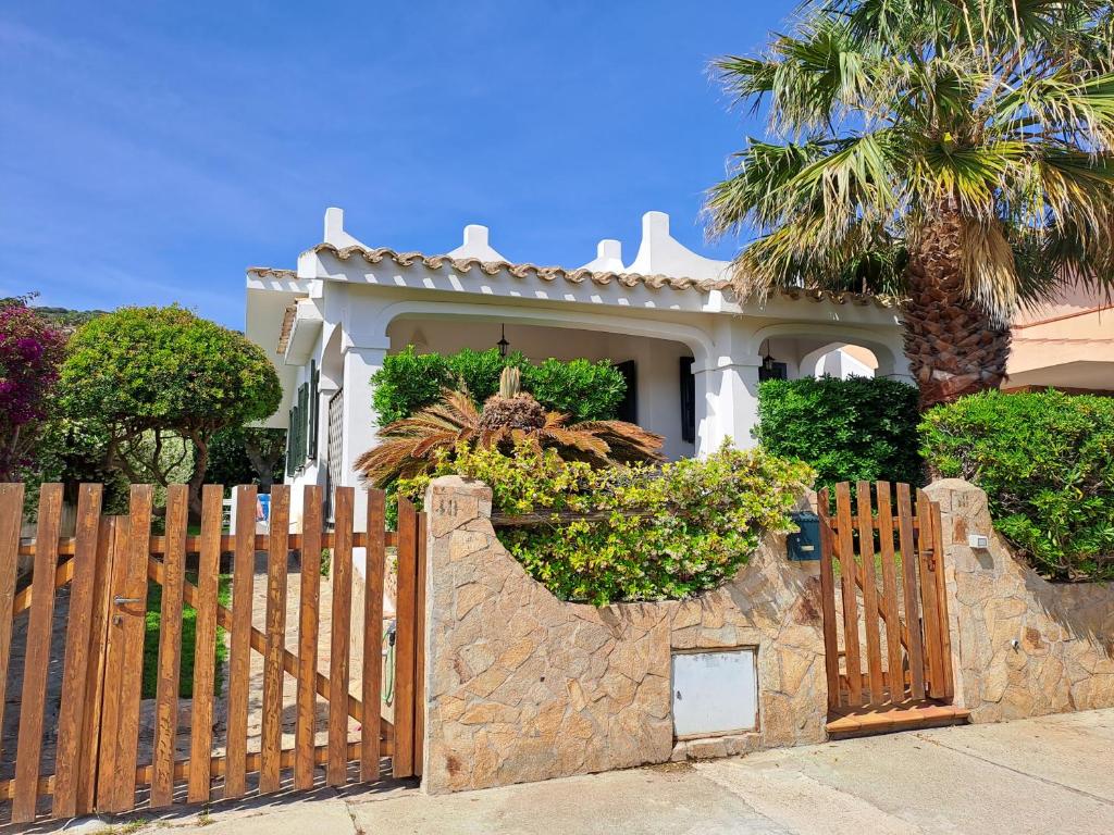 a wooden fence in front of a house at Sa Domixedda in Villasimius