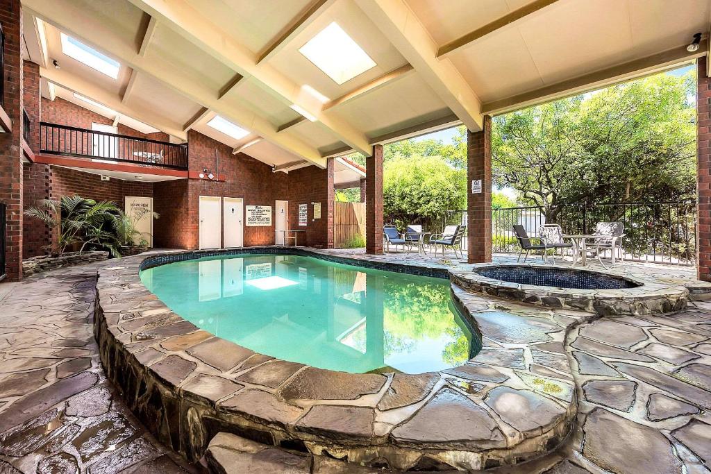 a swimming pool in a house with a patio at Comfort Inn & Suites Sombrero in Adelaide