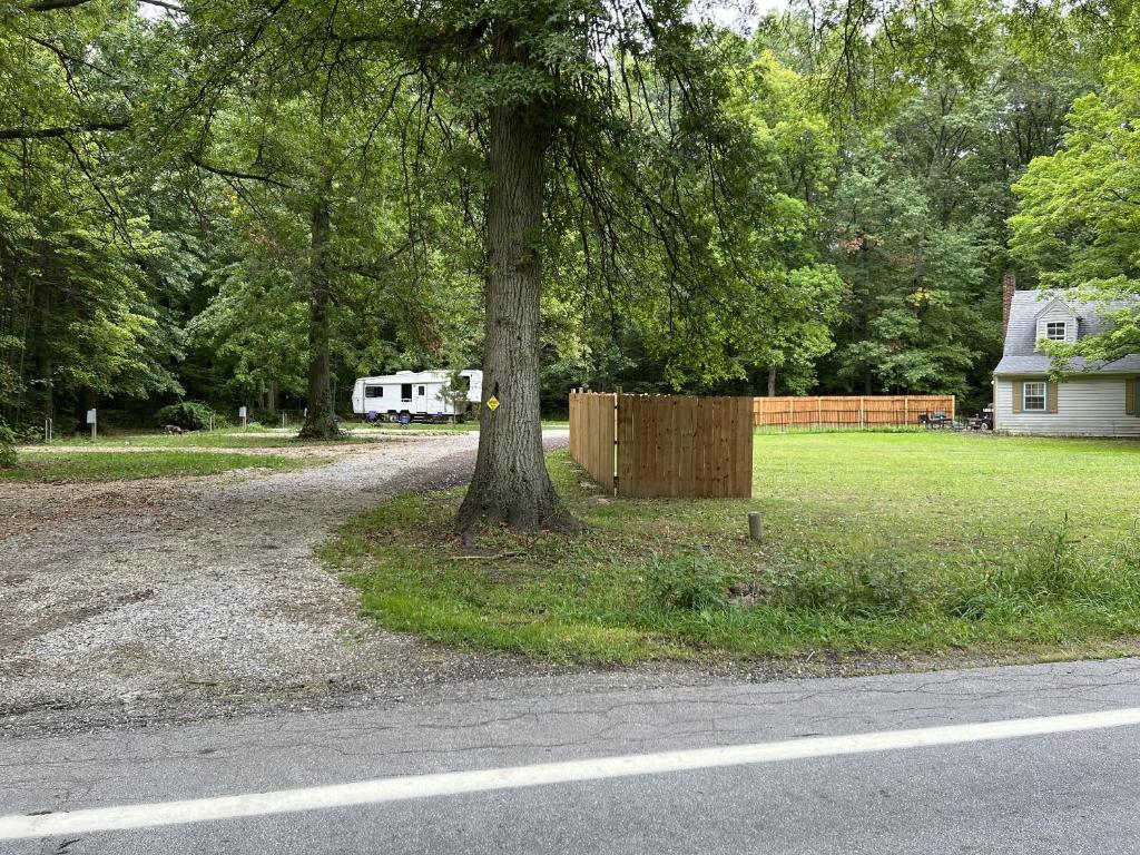 a tree on the side of a road next to a house at Prairie House RV Spaces in Deerfield