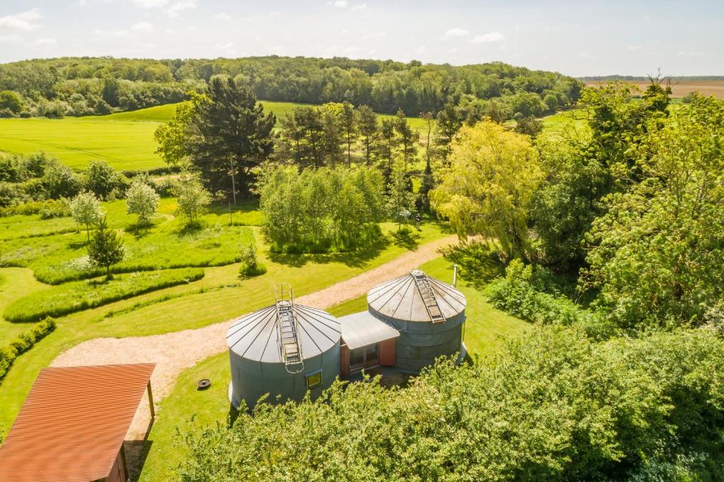 an aerial view of a farm with two silos at Extraordinarily converted grain stores - The Silos in Ipswich
