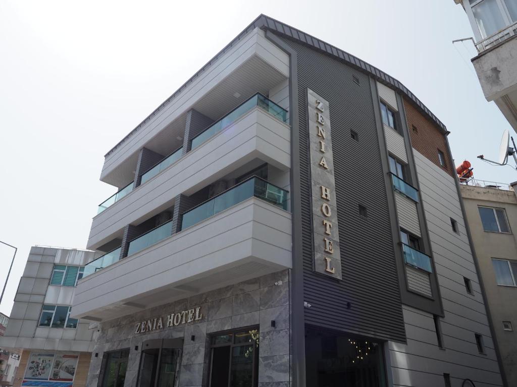 a building with a hotel sign on it at Zenia Hotel in Antalya