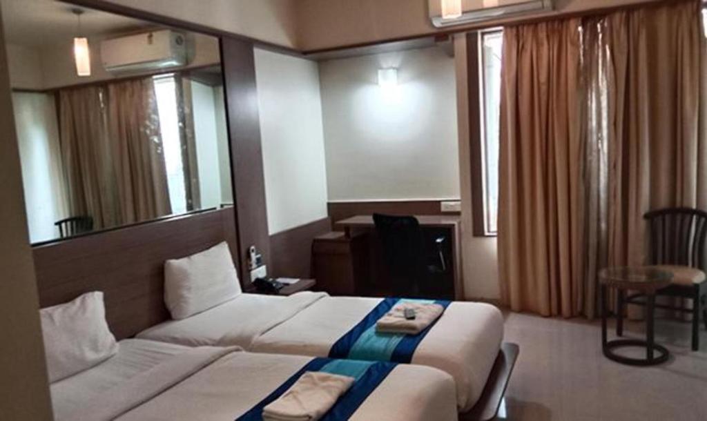 Postel nebo postele na pokoji v ubytování Hotel Prime Ivy Studio