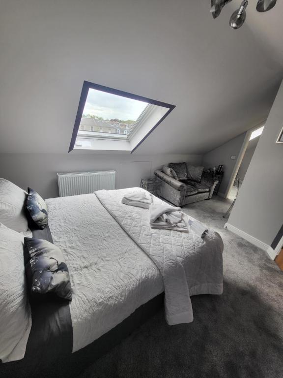 a bedroom with a large bed and a window at Lauderville guest house in Edinburgh