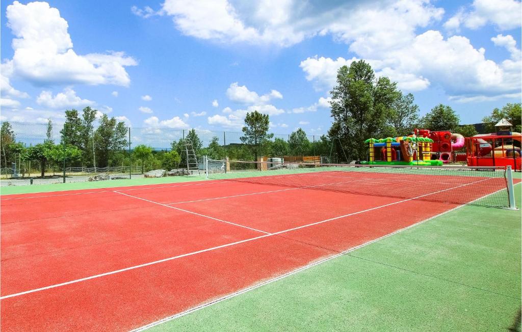 a tennis court with a playground with a water park at Amazing Home In Grospierres With Outdoor Swimming Pool, Wifi And 2 Bedrooms in Grospierres