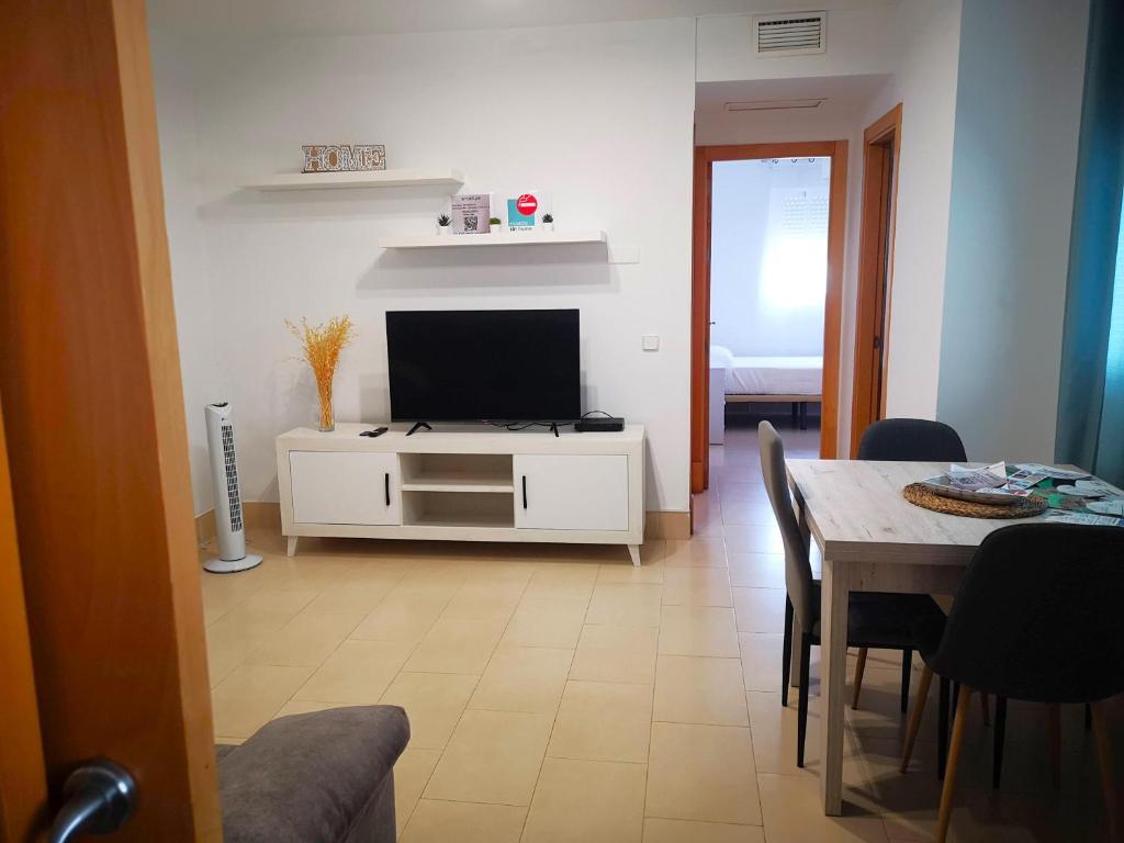 a living room with a television and a dining room table at Camposoto in San Fernando