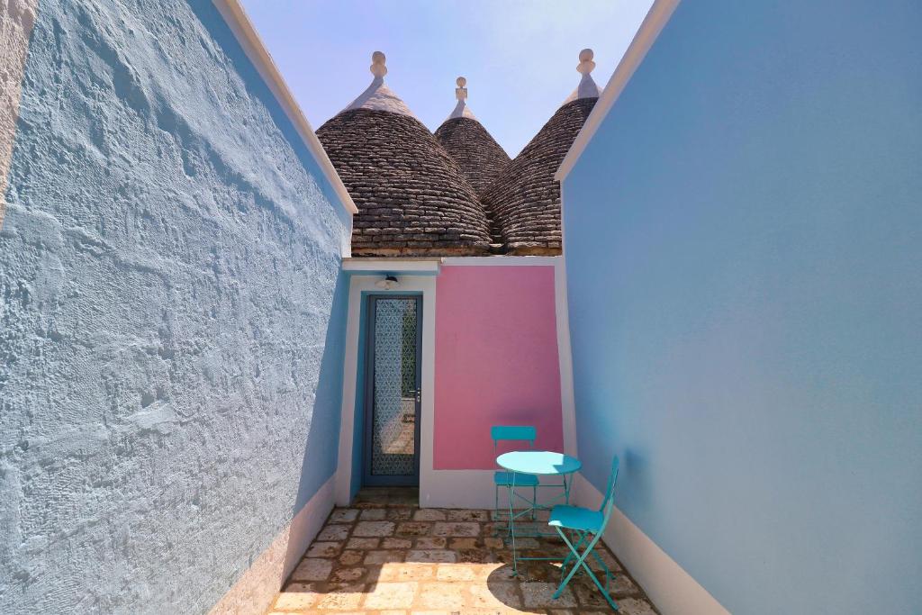 a hallway with a table and chairs in a building at Masseria Trullo Sovrano Exclusive B&B in Cisternino