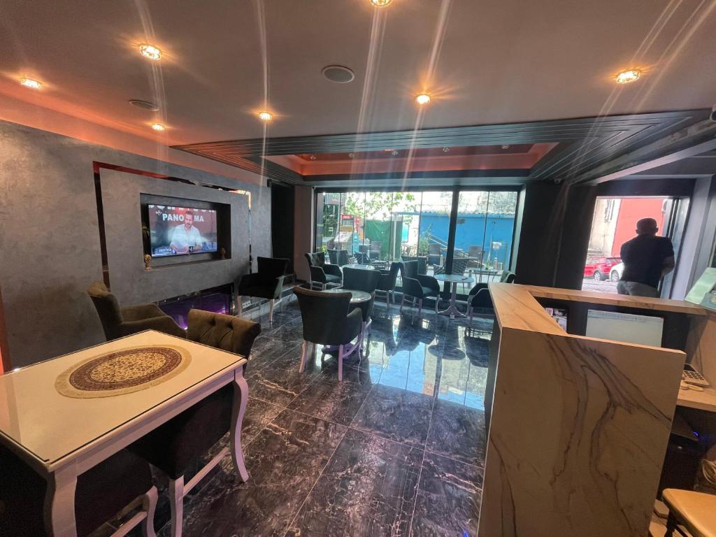 a restaurant with a dining room with tables and chairs at Grand Hurriyet Hotel in Istanbul