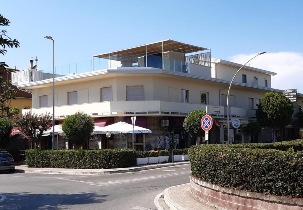 a building on a street with a road at Albergo del Lago in Capalbio