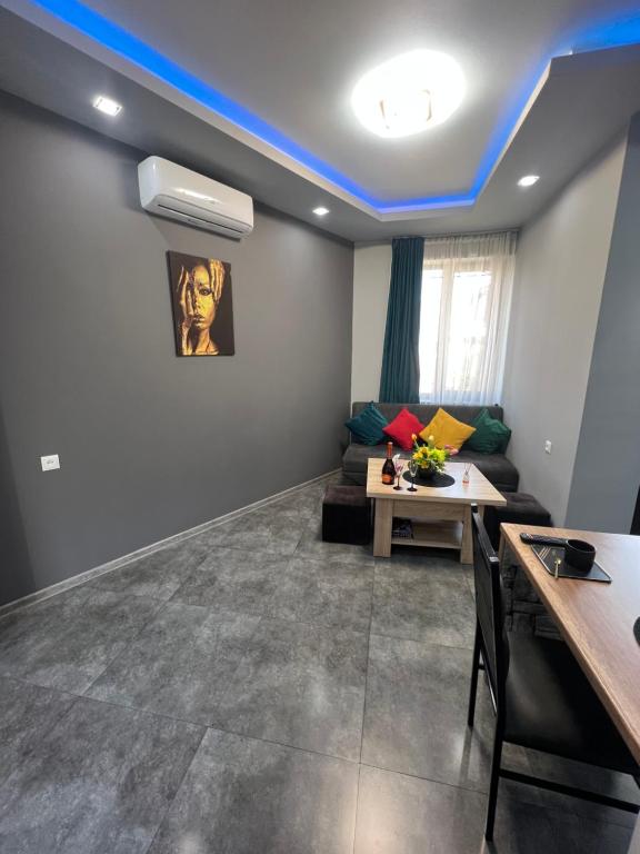 a living room with a couch and a table at COMFORTABLE APARTMENT КОМФОРТНЫЕ АПАРТАМЕНТЫ Self Check In in Yerevan