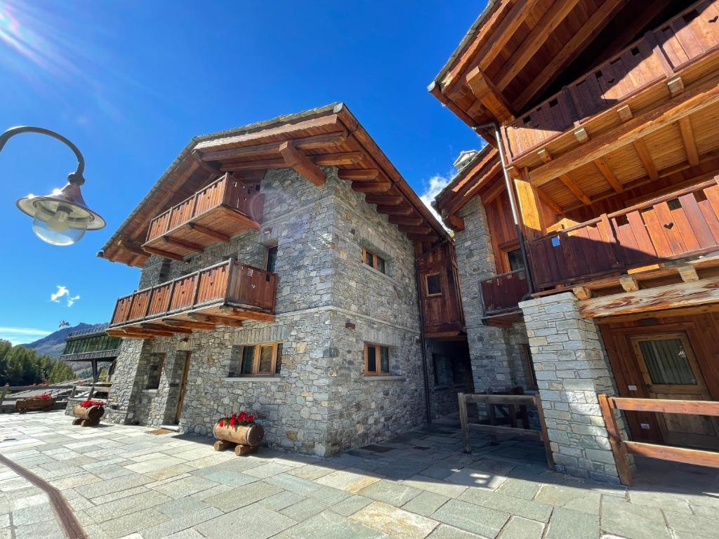 a building with wooden balconies on the side of it at Maison Carrel Elegant 6 in Breuil-Cervinia