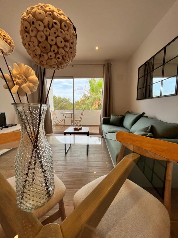 a living room with a couch and a vase at Apartamento en Costamar I, 2ª Planta, 23 in Es Pujols