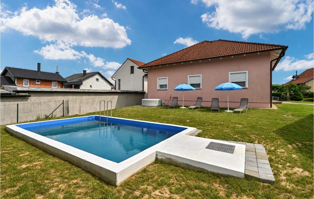 a backyard with a swimming pool in the grass at Lovely Home In Senkovec With Sauna in Slakovec