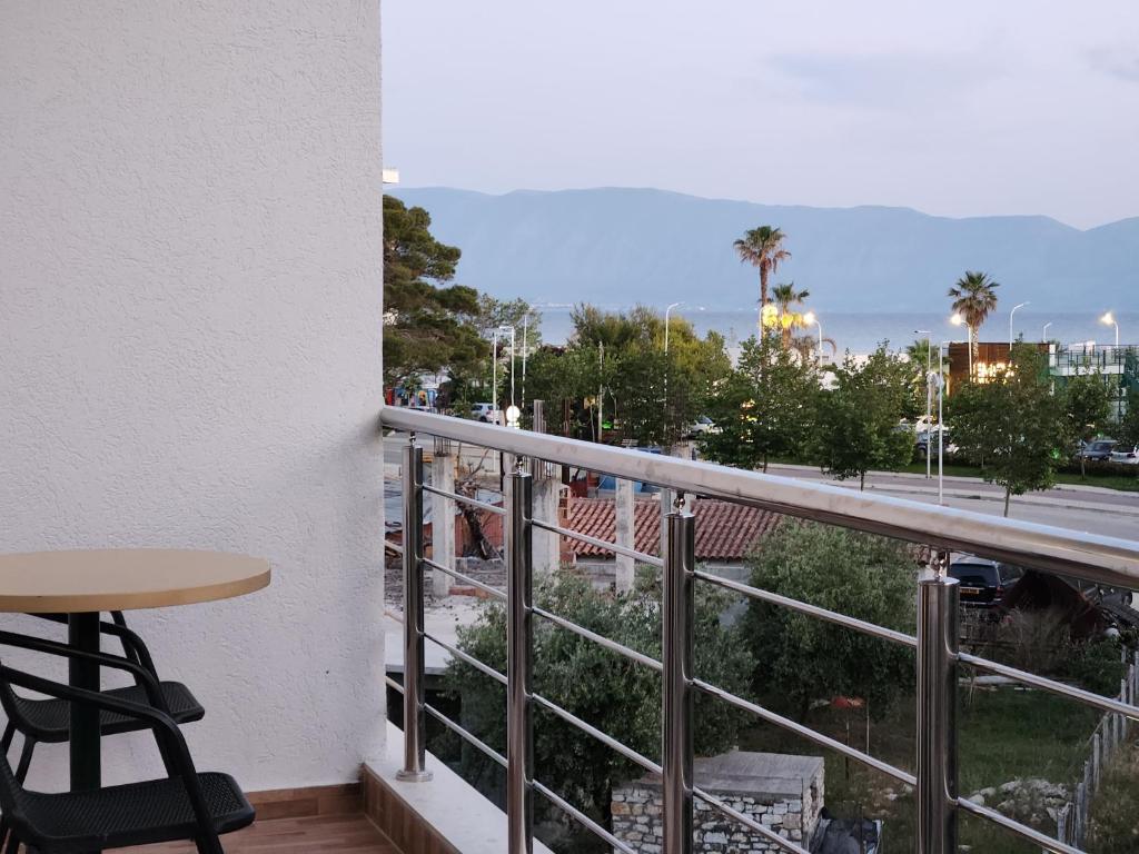 a balcony with a table and a view of a city at Sea Front Villa in Vlorë