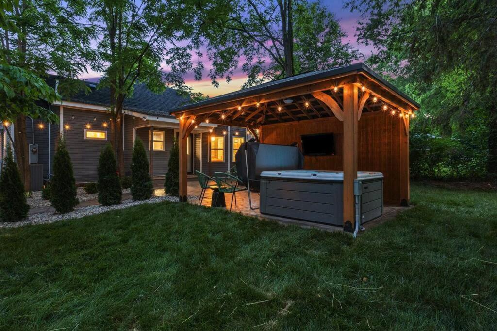 a barbecue under a gazebo in a yard at The Luxe/Hot Tub/12min to Horse Park/30 Min to Ark in Georgetown