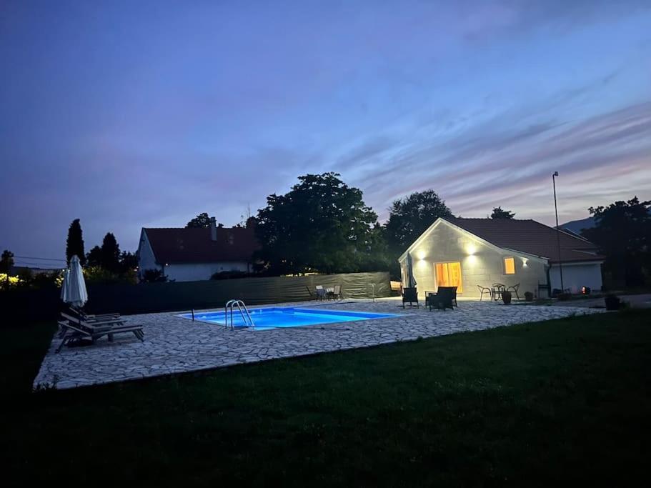 a tent with a pool in a yard at night at Pool & River House - Lazara in Danilovgrad