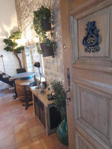 une chambre avec une porte et une table avec une plante dans l'établissement L Estello, Village house in Provence, à Seillans